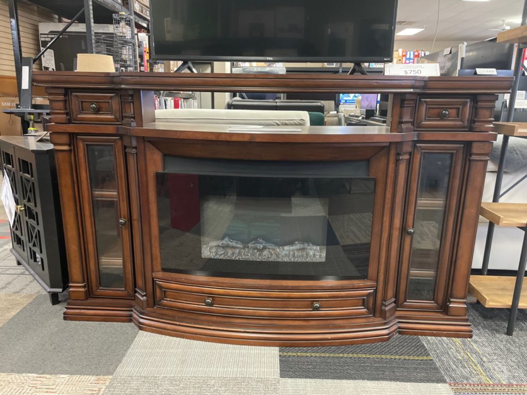 Large dark wood TV console with fireplace insert