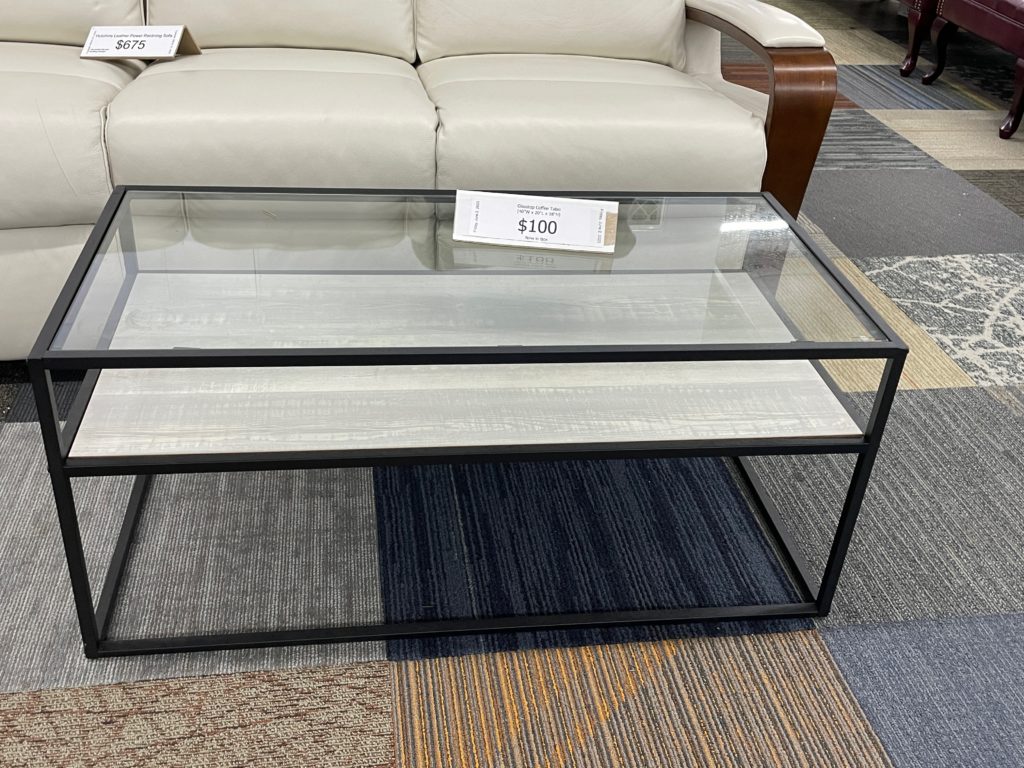 Glass top coffee table with shelf