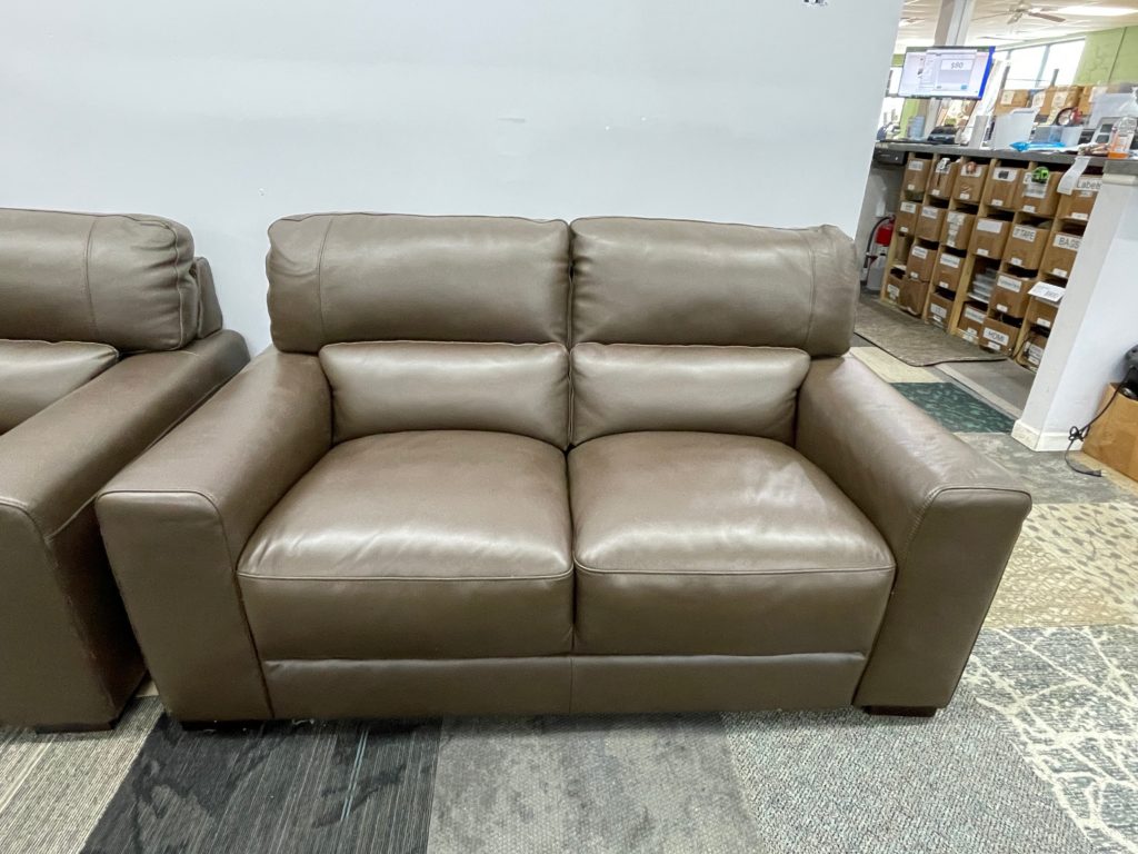 Brownish gray leather love seat
