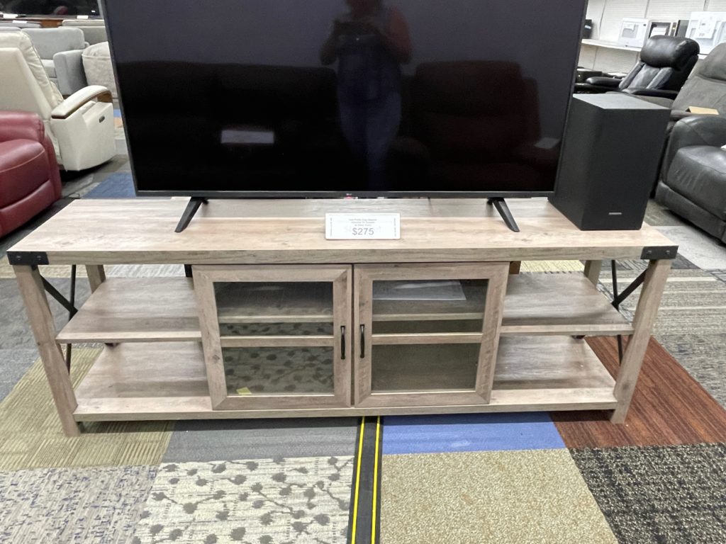 Light wood color tv console with 2 glass doors and 4 shelves