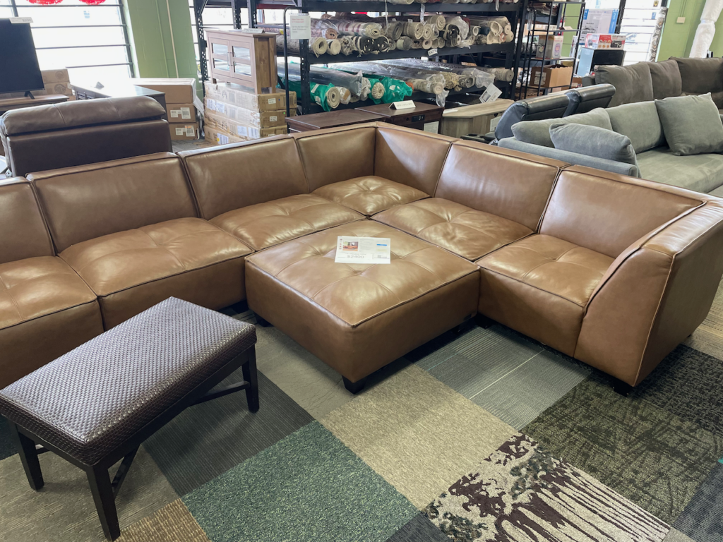 Brown leather sectional with ottoman