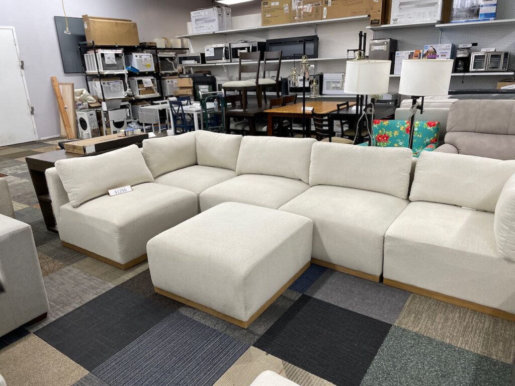 White fabric sectional with ottoman