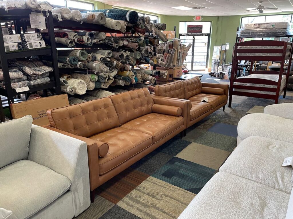 Brown leather couches and rugs