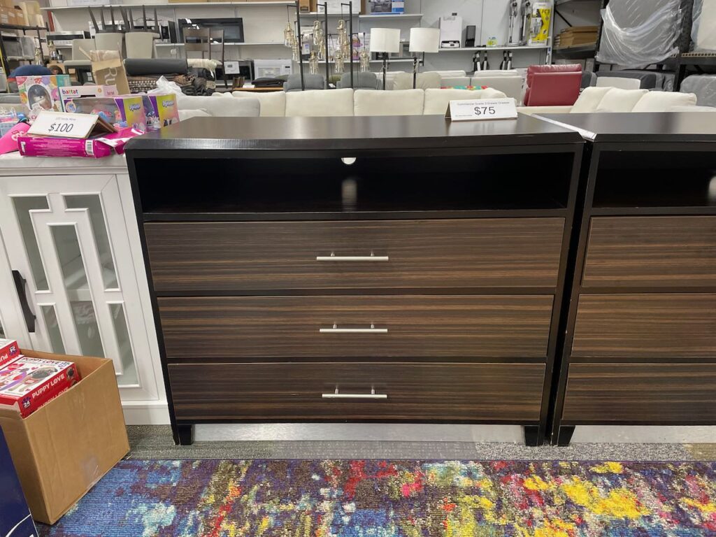 Wood tone TV console with 1 shelf and 3 drawers