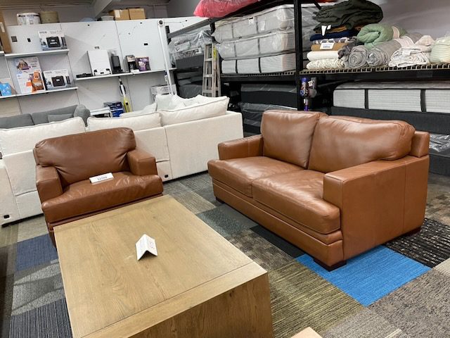Brown leather couch and love seat
